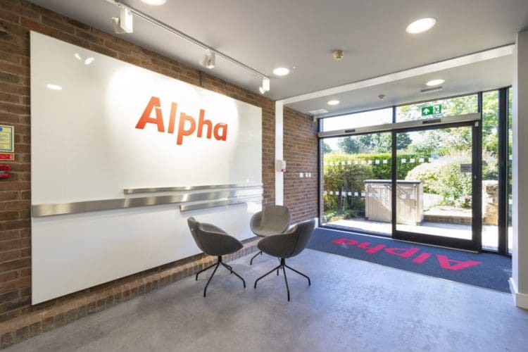 Office reception area design with bespoke entrance mat and sliding doors