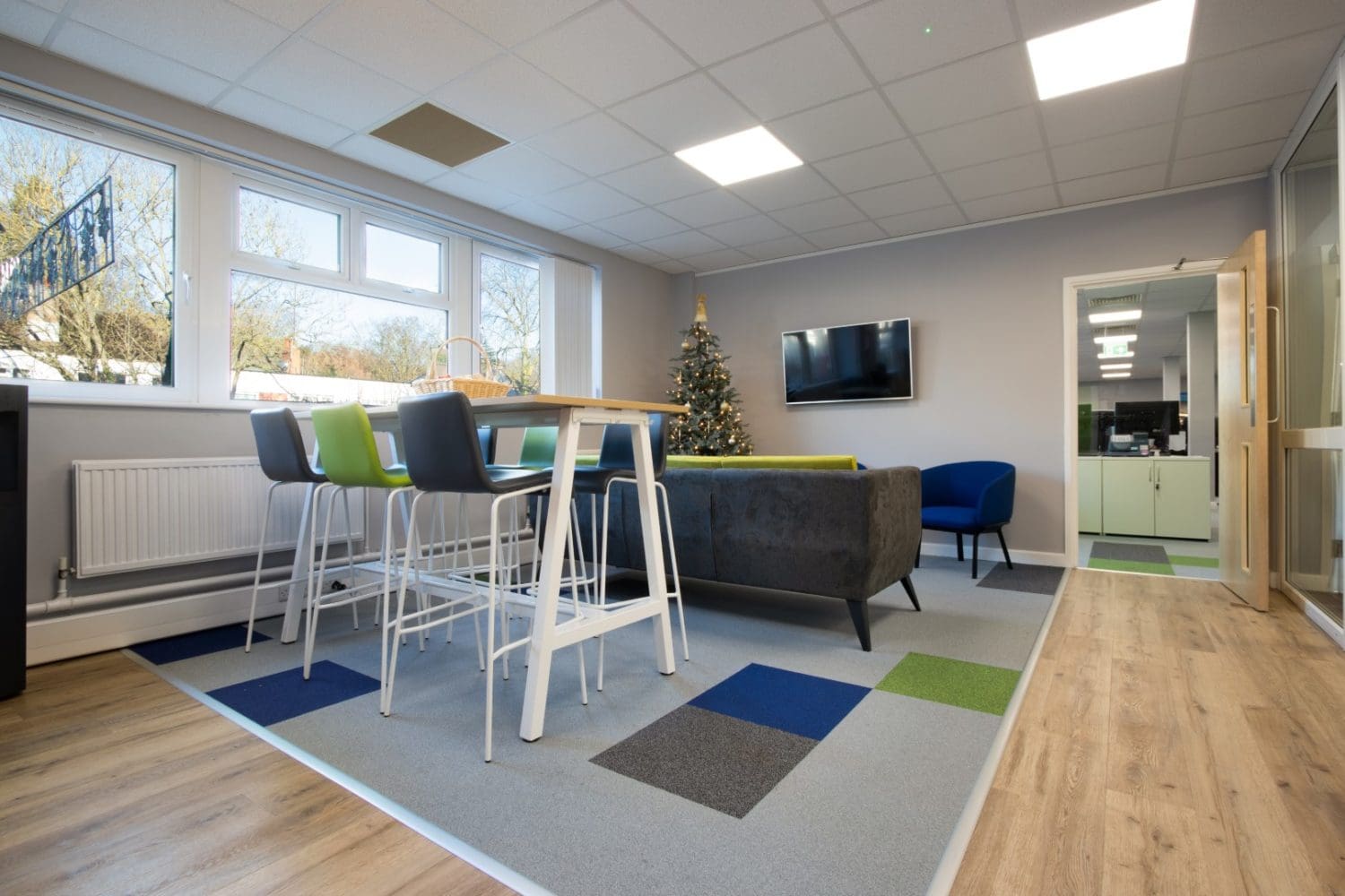 Office breakout area interior design with dining furniture and new carpet