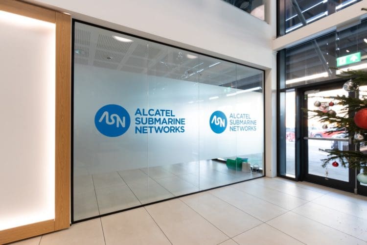 Glass office reception partition with frosting and a company logo