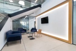 Stud and track wall with a timber surround for an office reception refurb