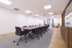 Corporate office meeting table with integrated power for modern office refurbishment.