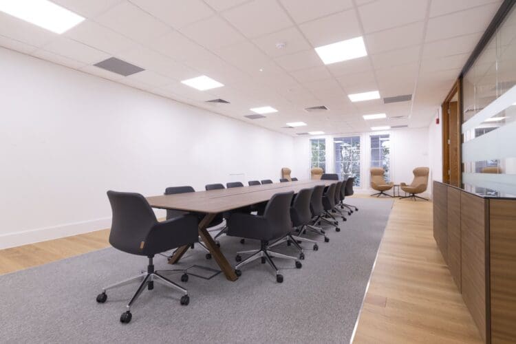 Corporate office meeting table with integrated power for modern office refurbishment.