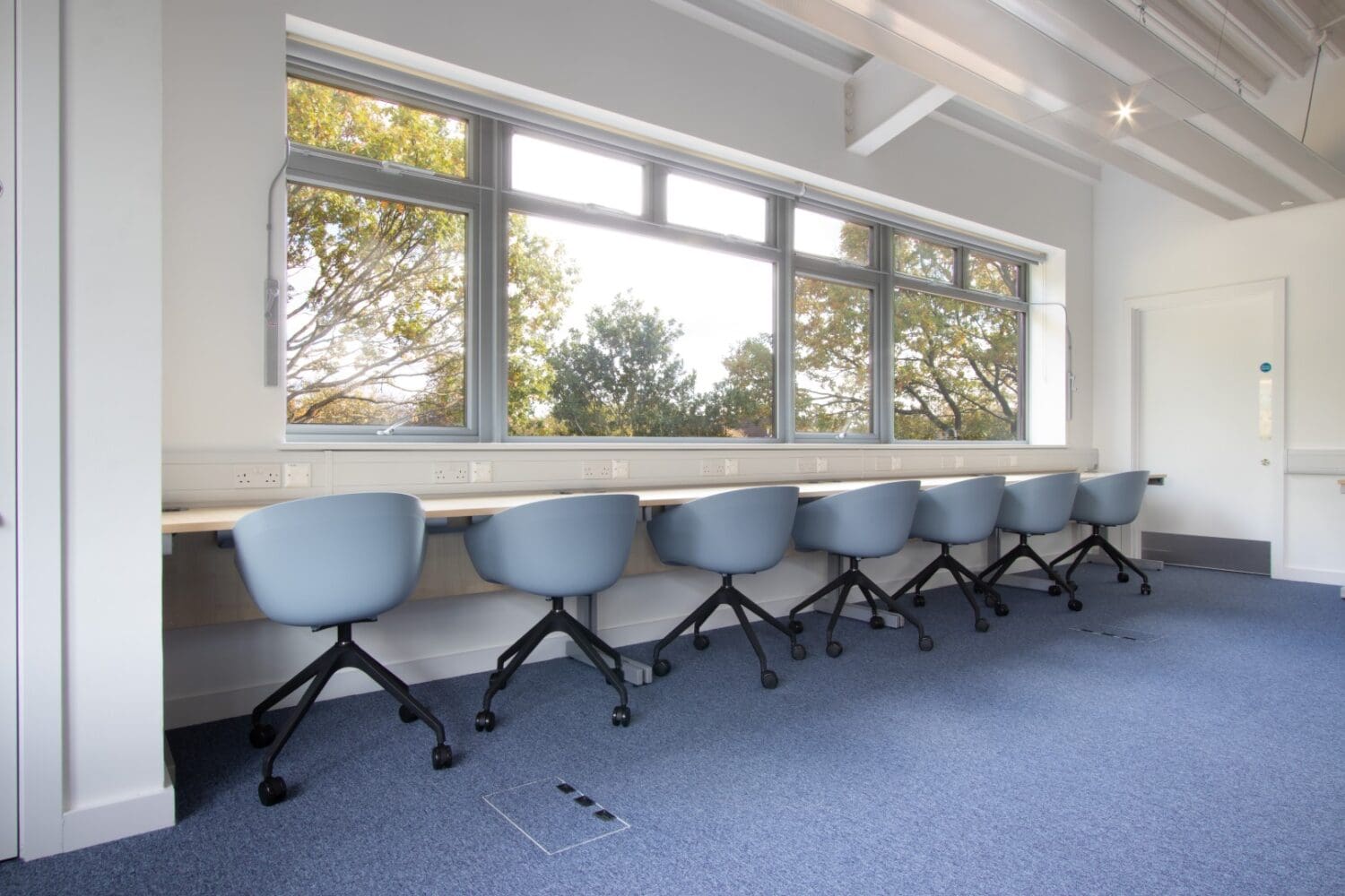 Bucket chairs on swivel base with castors for new school classroom in London.