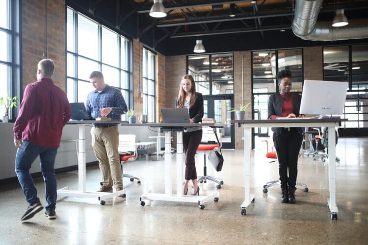 Sit-stand desk office furniture solution for employee wellbeing.