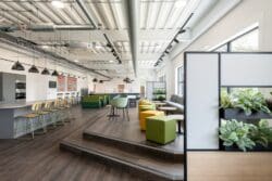 Banquet seating and coffee tables in breakout space for an industrial warehouse fit out project.