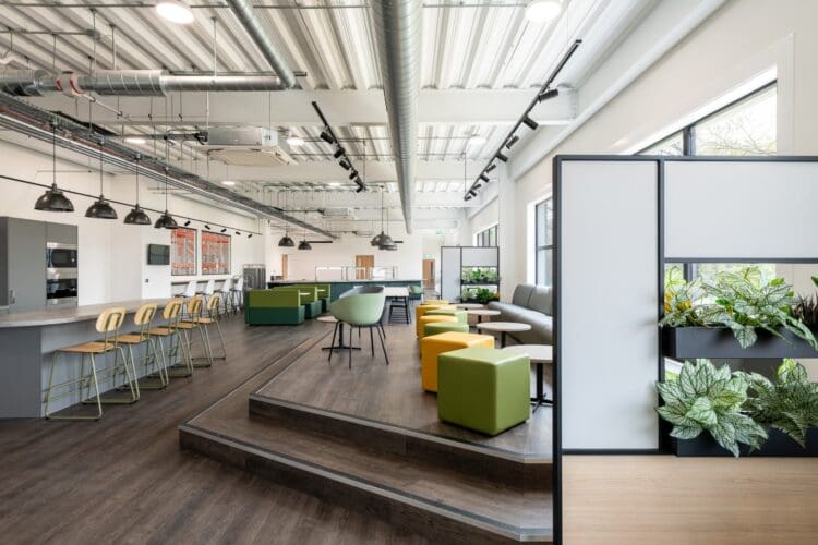 Banquet seating and coffee tables in breakout space for an industrial warehouse fit out project.