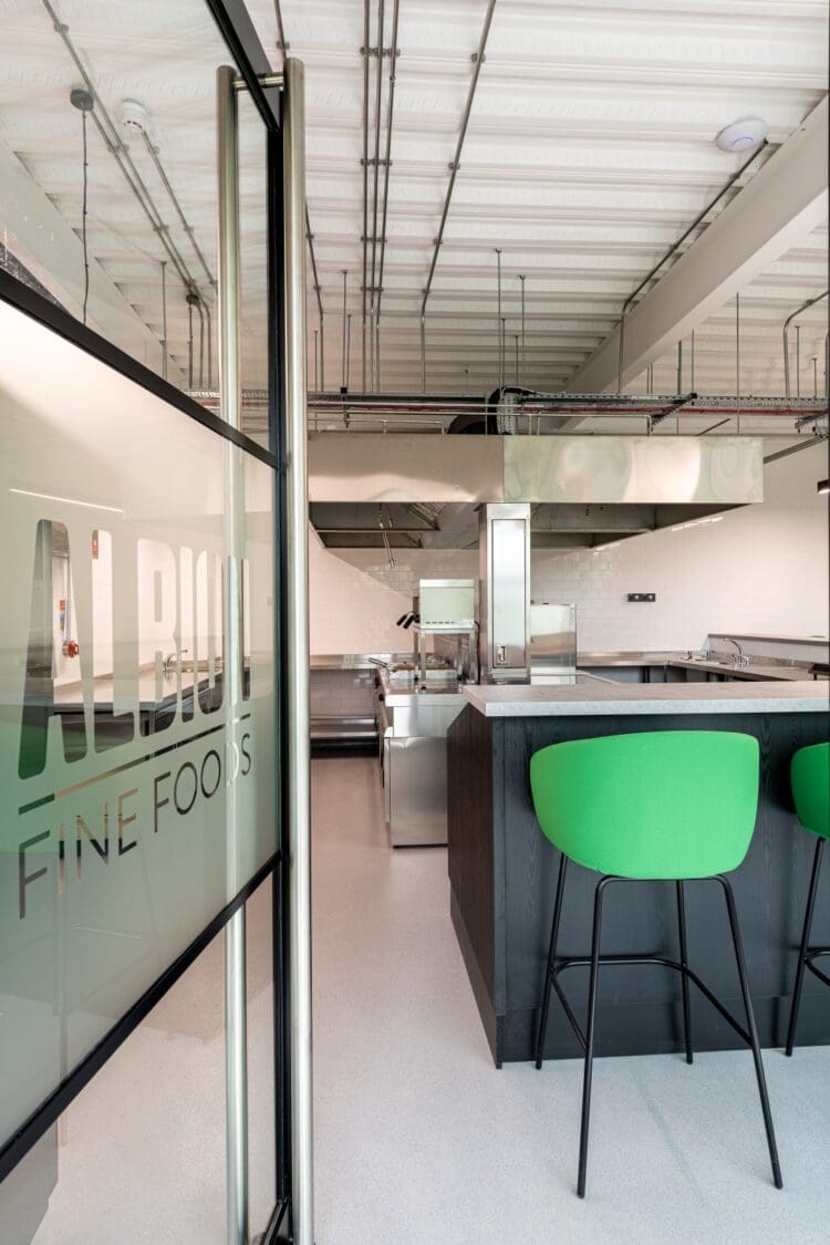 Commercial tasting kitchen at Albion Fine foods industrial unit, with branded glass manifestation.