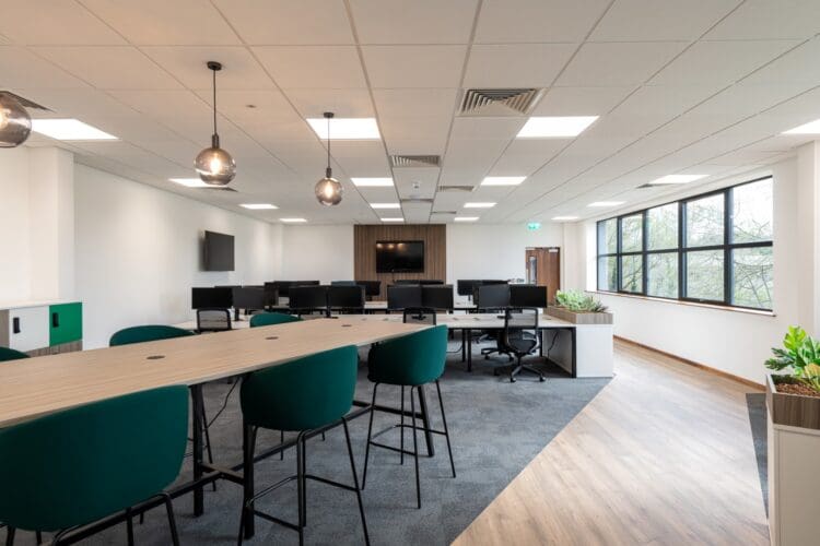 Collaboration table and stools in an open plan workspace for an industrial warehouse fit out.