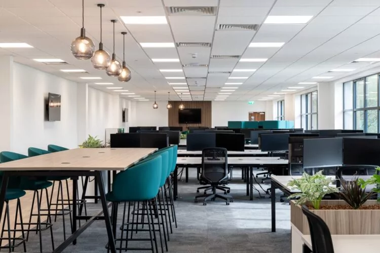 A sleek and modern office interior design with meeting tables and office desking.
