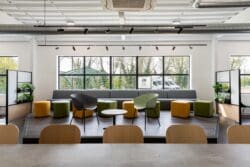 Elevated seating area with banquet seating and coffee tables. Complimentary branding colours.