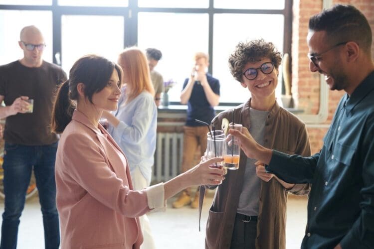Office workers enjoying a drink together to instil a sense of community and social times within the office day.