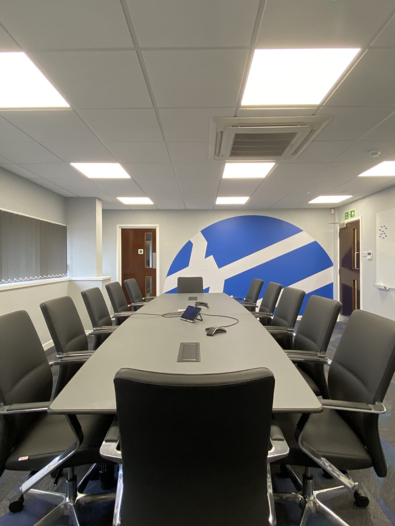 Boardroom refurbishment with company logo graphic on feature wall behind at Wire Belt in Sittingbourne, Kent.
