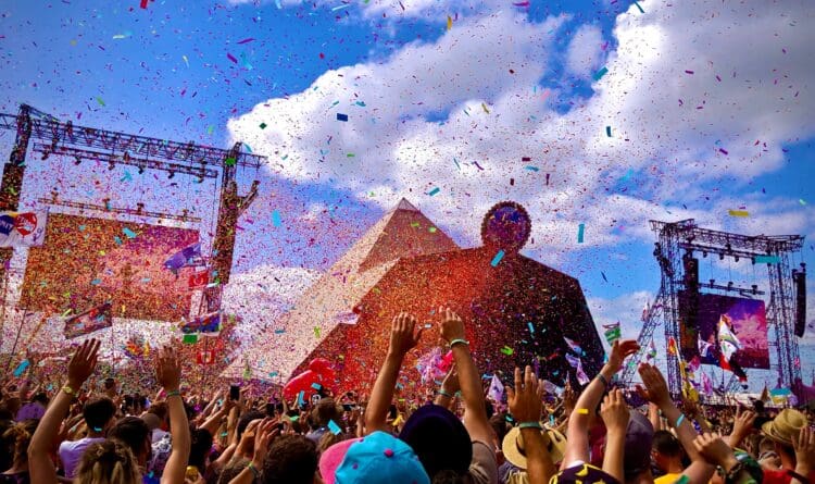 Music lovers enjoying performances at the Pyramid stage at Glastonbury Music Festival.