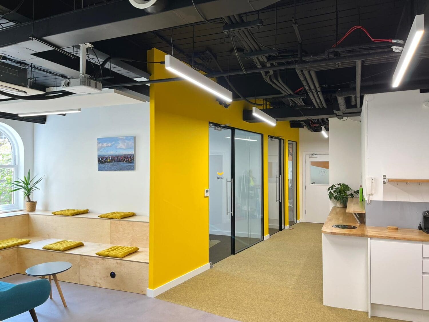 Office breakout space with meeting rooms and tea point.