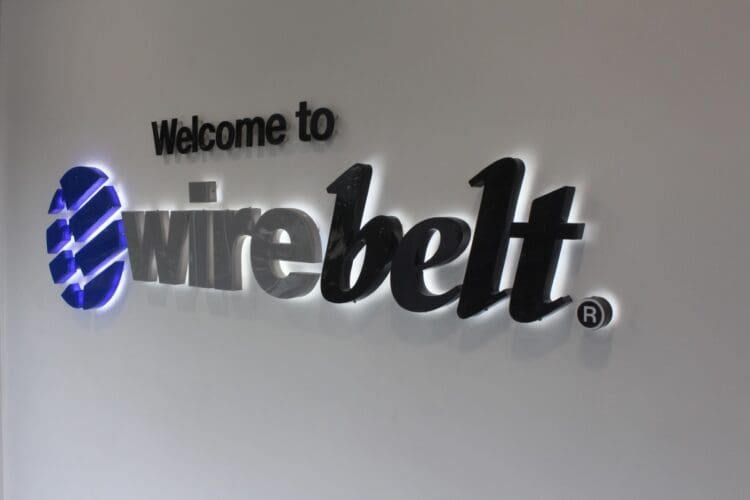 Wire Belt company logo in perspex stand off wall graphics in an office interior design scheme.