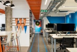 Office refurbishment project in London with height adjustable desks and company branding.