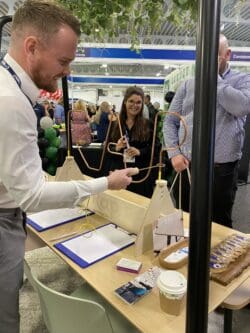 man playing wire buzz game at the rap interiors stand
