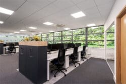 Bright modern office interior design with modern desking and storage units.