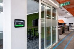 Glazed fronted meeting room with branded manifestation in London office refurbishment.