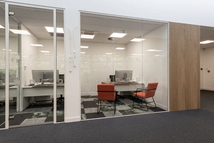 Glazed private office and wooden slat feature wall.
