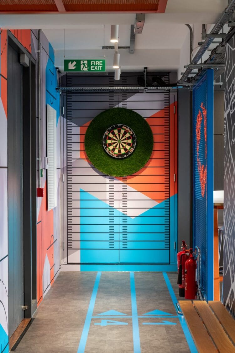 Modern office interior design with dart board and oche point.