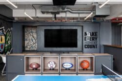 Office breakout space with bespoke wall mounted media unit.