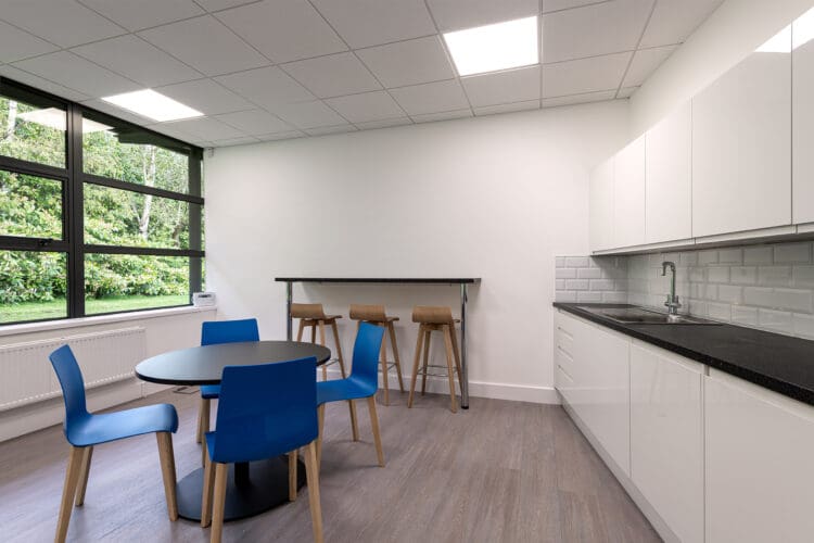 Office kitchen area with breakfast bar and modern furniture solutions.