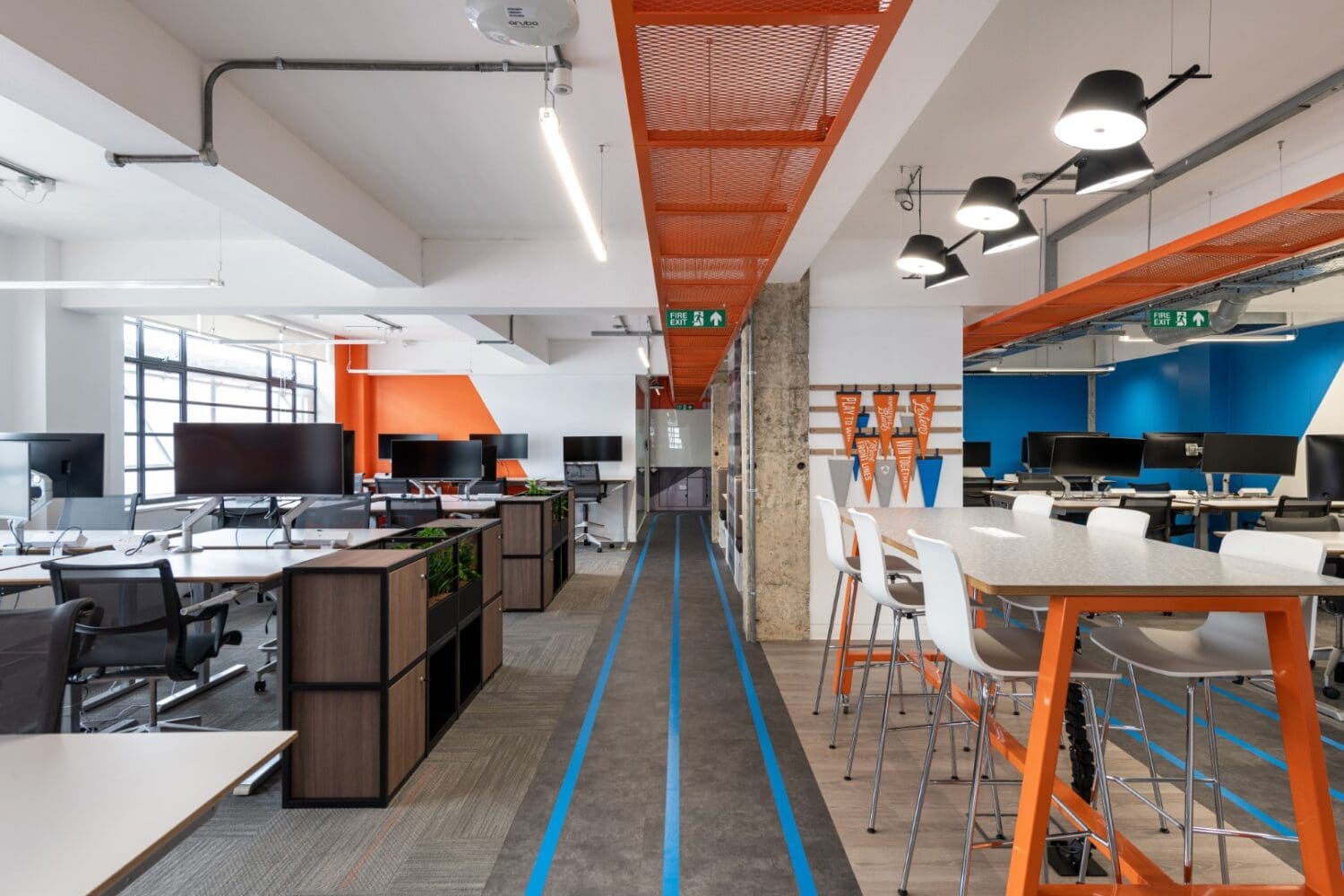 Open plan office with modern office furniture solutions and branded colours.