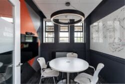 Private meeting room in London office refurbishment project with feature lighting and acoustic panels.