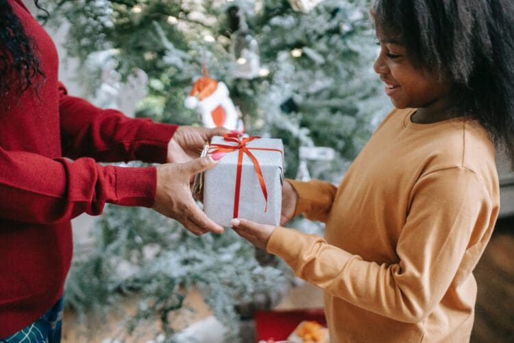 Child receiving gift at Christmas.