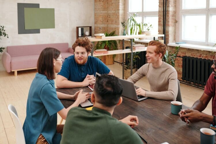 Colleagues collaborate in modern coworking office space.