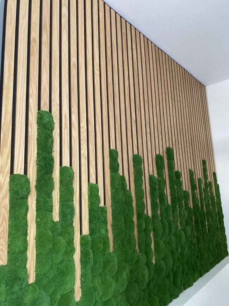 Office feature wall with slat and moss inserts.