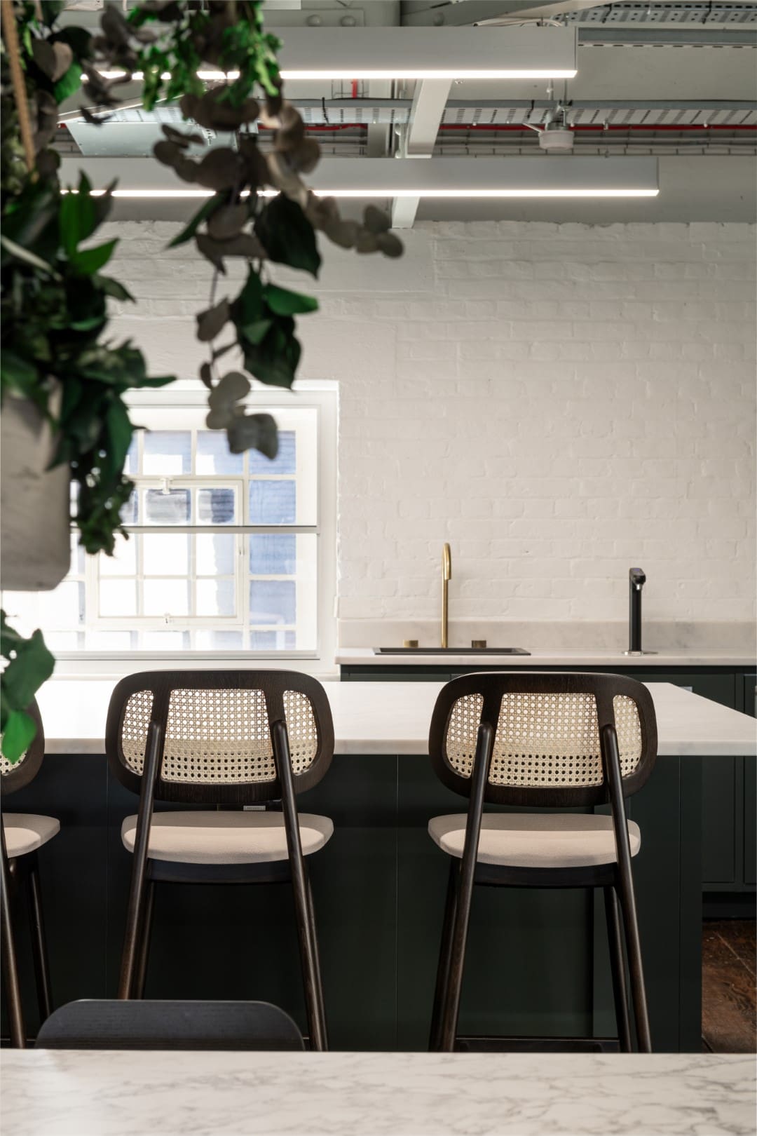 Kitchen breakfast bar stools in office kitchen area.