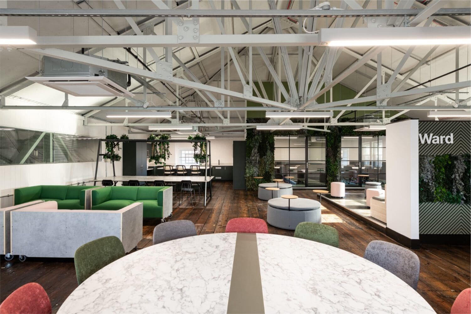 Large open plan office breakout space with expose architectural features.