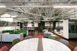 Large open plan office breakout space with expose architectural features.