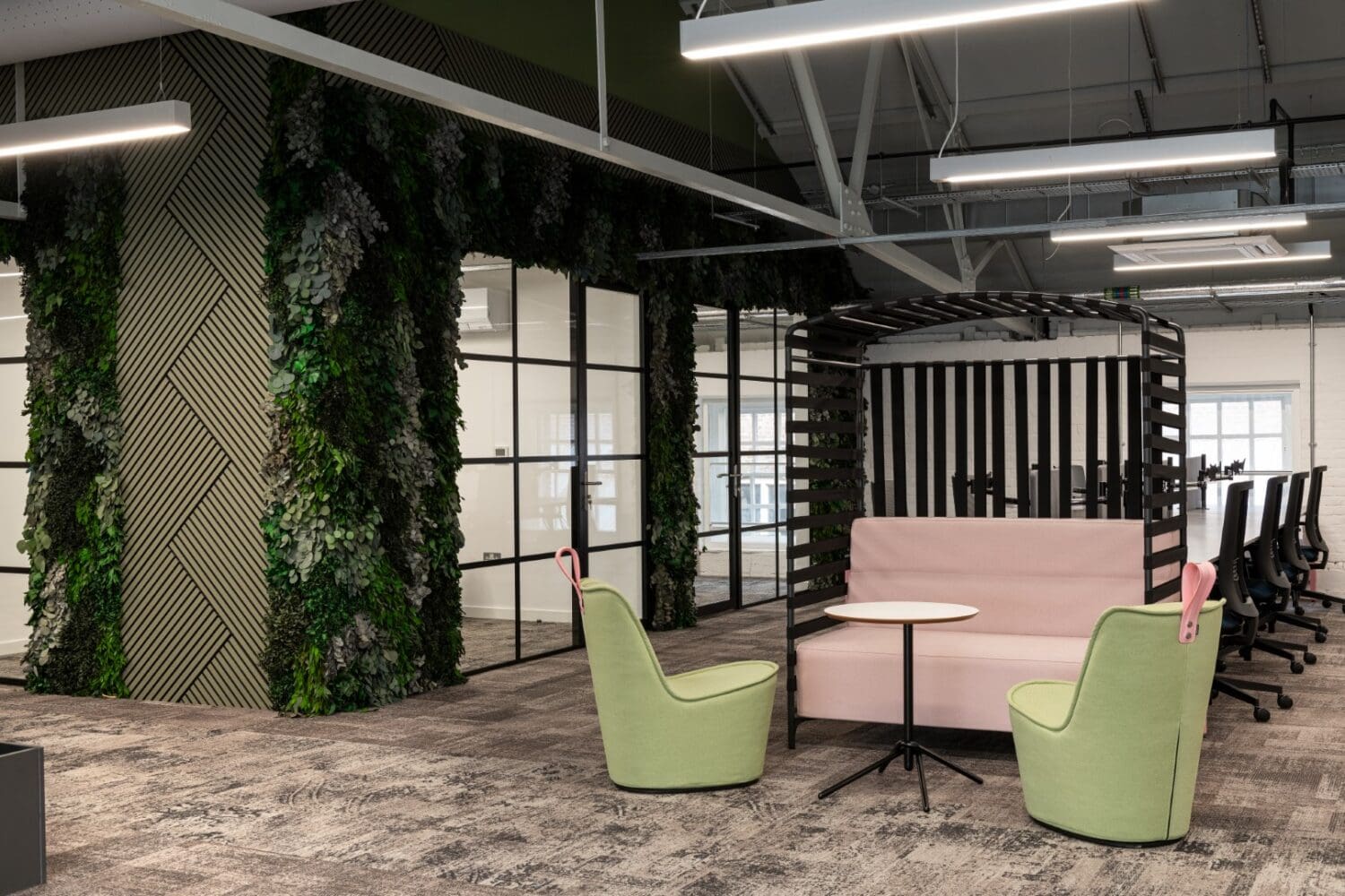 Meeting booth and individual seating in open plan office space.