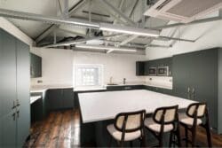 Office kitchen area design with large central island.