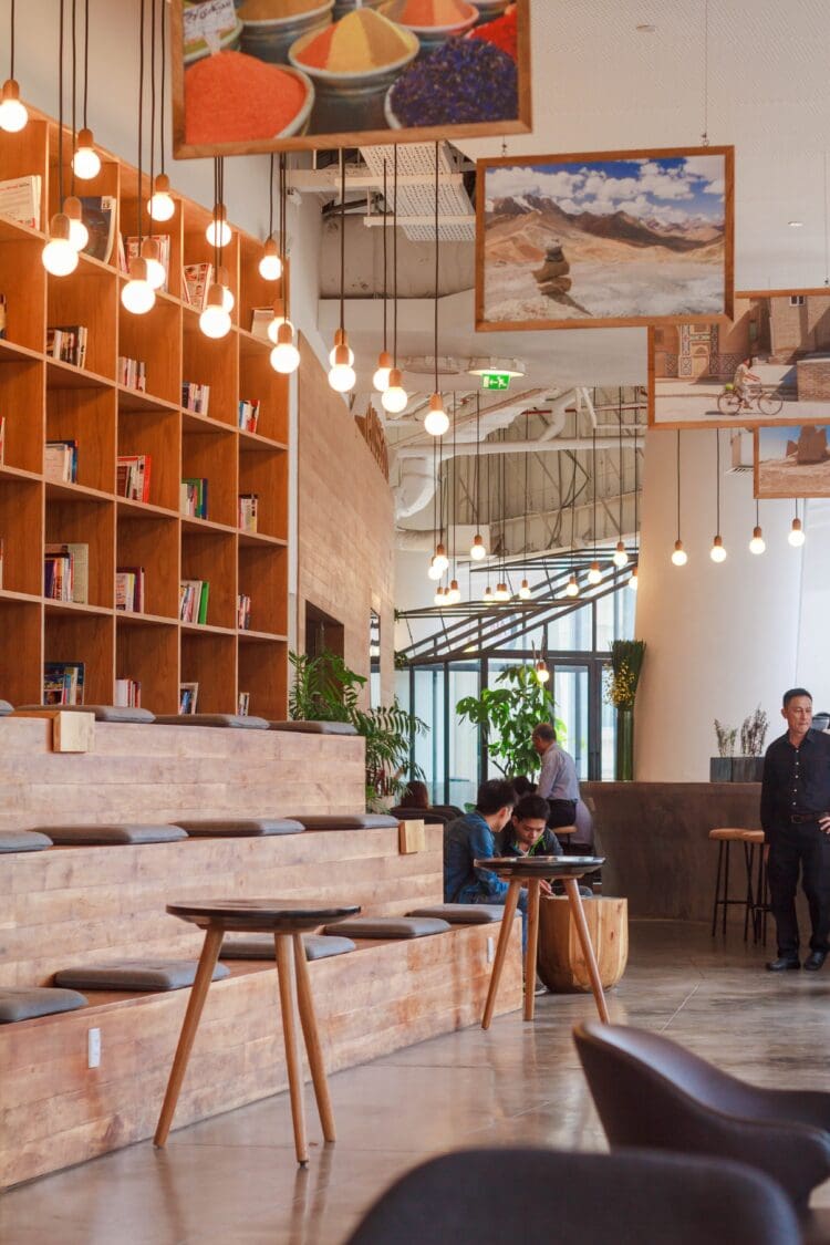 Office breakout space with bleacher seating and festoon lighting.