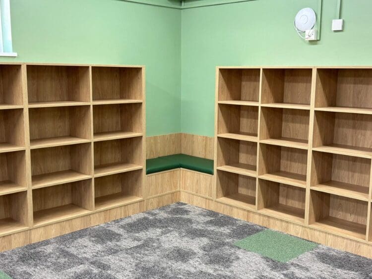 Bespoke book shelves and reading nook in school library refurbishment.