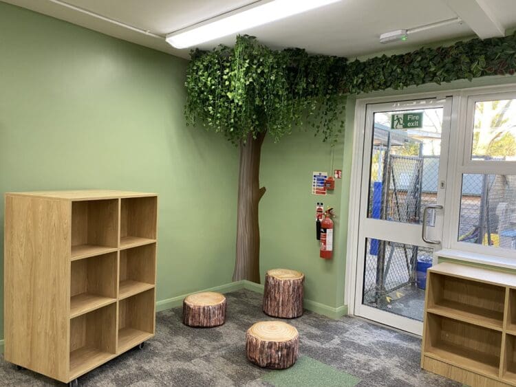 Tree manifestation and hanging foliage reading corner in school library refurbishment, London