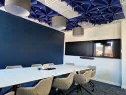 Large office meeting room design with acoustic ceiling tiles and office furniture solutions.
