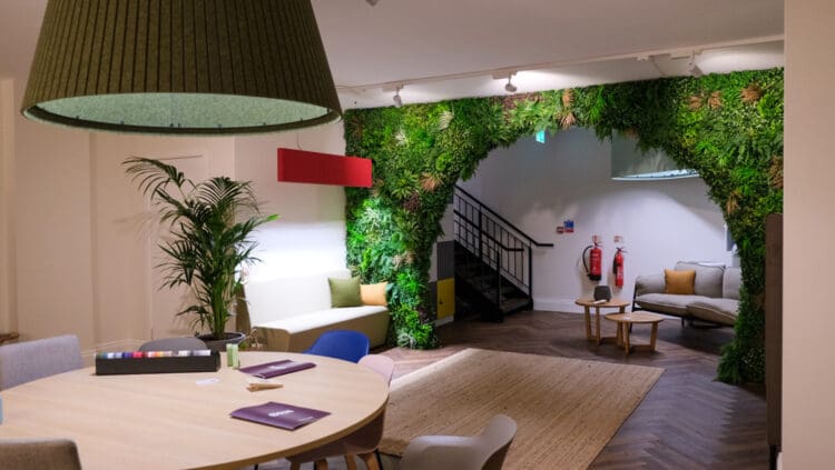 Orn Furniture showroom design with large pendant light and biophilic wall.