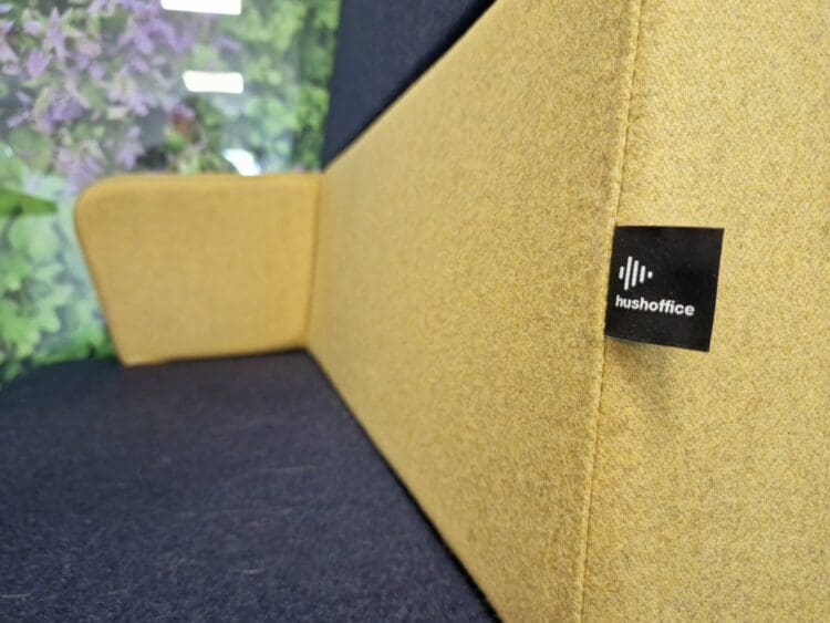 Upholstered seat in individual office pod by Hush Office.