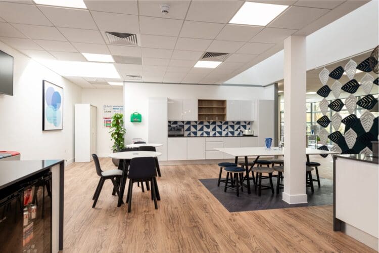 Cafe style furniture in modern office breakout space.