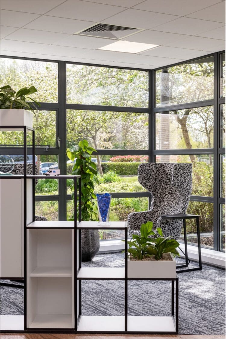 Tiered office storage and soft seating in office breakout space.