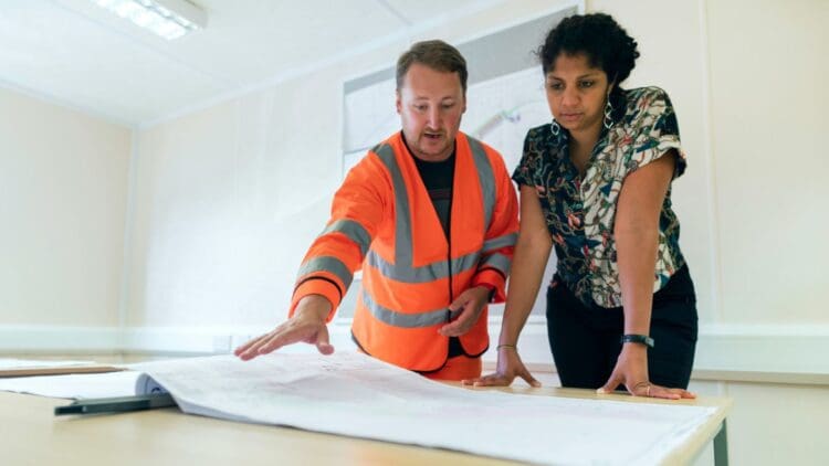 Construction meeting discussing office fit out plans with principal designer and project manager.