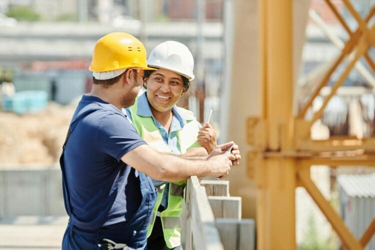 Principal designer on construction site with contractor.