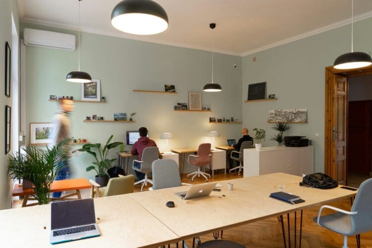 Coworking office design with hot desking system and collaborative work stations.