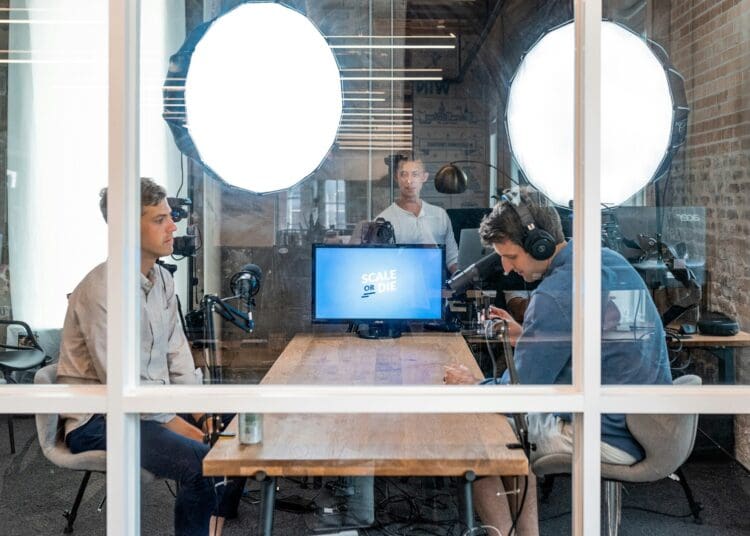 Dedicated podcasting room in office with company branding.