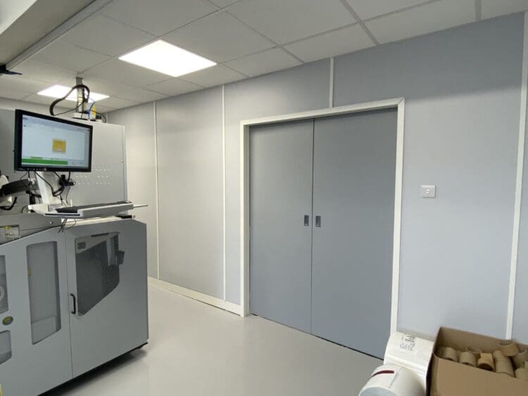 Sliding doors in warehouse refurbishment with suspended ceiling.
